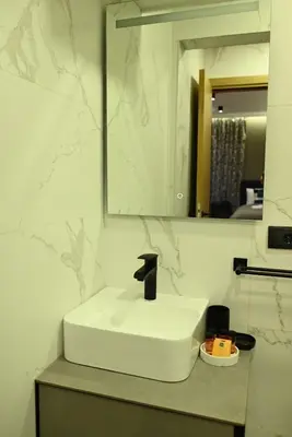 a bathroom with a white sink and a mirror at Paradiso 2 in Leskovac