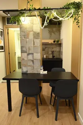 a black table and chairs in a room at Paradiso 2 in Leskovac
