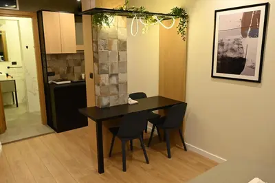 a kitchen and dining room with a table and chairs at Paradiso 2 in Leskovac