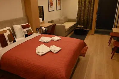 a hotel room with a bed with towels on it at Paradiso 3 in Leskovac