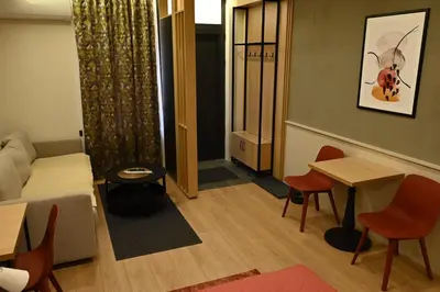 a living room with a couch and a table and chairs at Paradiso 3 in Leskovac