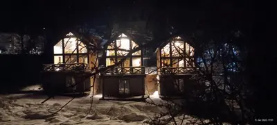 a house in the snow at night at Ski & Spa Bungalows in Kopaonik