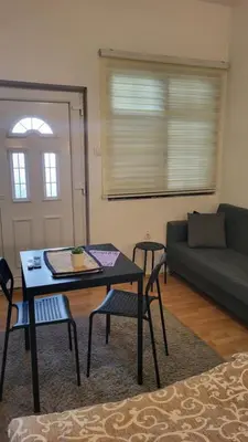 a living room with a table and chairs and a couch at Studio Janko in Vrnjačka Banja