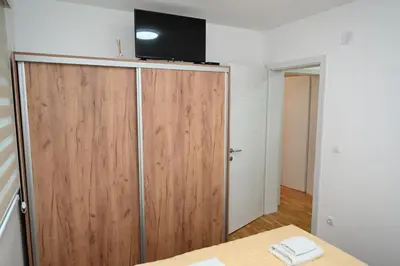 a sliding door with a television on top of it at Apartman A&A lux in Vrnjačka Banja