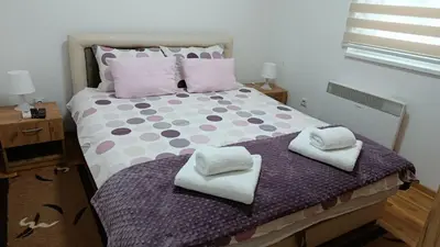 a bedroom with a bed with two towels on it at Apartman A&A lux in Vrnjačka Banja