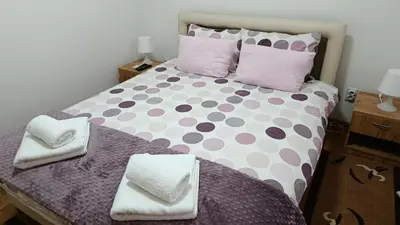 a bedroom with a large bed with polka dots at Apartman A&A lux in Vrnjačka Banja
