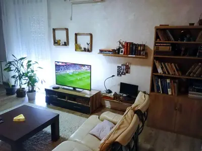 a living room with a couch and a flat screen tv at Lux aprtman in Leskovac