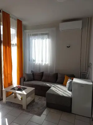 a living room with a couch and a table at Studio apartman Beus in Kuršumlija