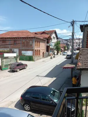 a black car parked on the side of a street at Studio apartman Beus in Kuršumlija
