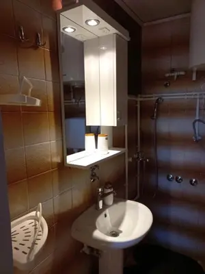 a bathroom with a sink and a mirror at Studio apartman Beus in Kuršumlija