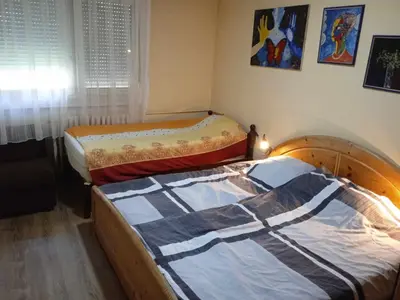 a bedroom with two beds and a window and acknowled at LUX Apartman in Leskovac