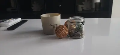 a table with a cup and a jar of food at Cera premium apartment in Soko Banja