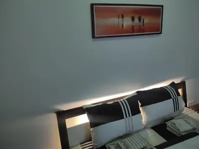 a room with a couch with a picture on the wall at Cera premium apartment in Soko Banja