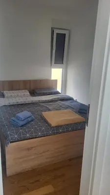 a bedroom with a bed with blue pillows on it at Milica i Vuk in Vrnjačka Banja