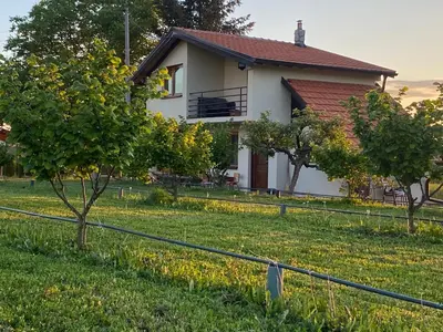 a house with a fence in front of a yard at s t d -PARADISO- in Vranje