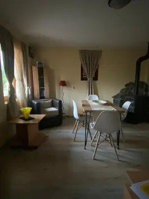 a living room with a table and chairs and a couch at s t d -PARADISO- in Vranje