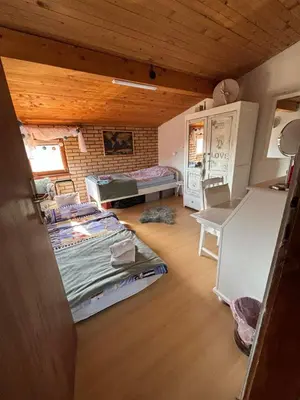 a room with two beds and a brick wall at Apartmani Milanović Jagodina in Jagodina