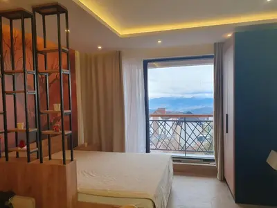 a bedroom with a bed and a large window at Residence hill Studio Rocco in Kopaonik