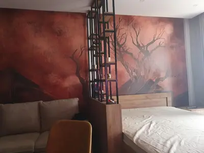 a bedroom with a bed and a painting on the wall at Residence hill Studio Rocco in Kopaonik