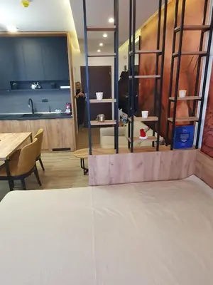 a room with a table and some chairs and a counter at Residence hill Studio Rocco in Kopaonik