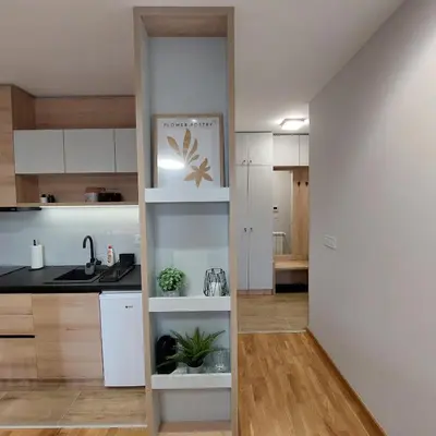 a kitchen with white cabinets and a sink at Studio Vera in Kruševac