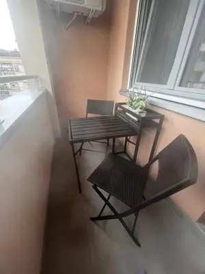 a table and chairs in a room with a window at Studio Vera in Kruševac