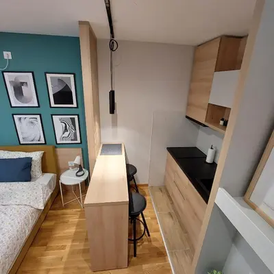 a small room with a bed and a desk in it at Studio Vera in Kruševac