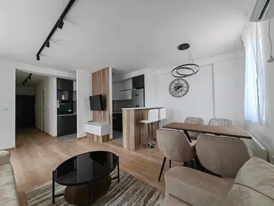 a living room with a table and a couch at Apartman Petra in Niš