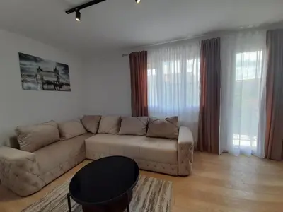a living room with a couch and a table at Apartman Petra in Niš