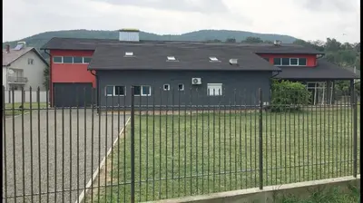 a fence in front of a house with a yard at Rezidencija Arion in Kraljevo