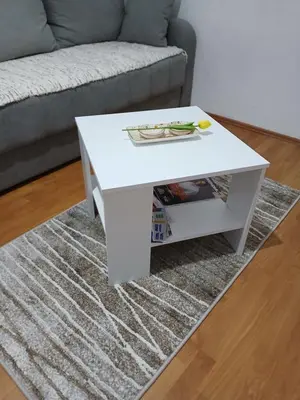 a white coffee table in a living room with a couch at Apartman AM Mladenović in Vranje