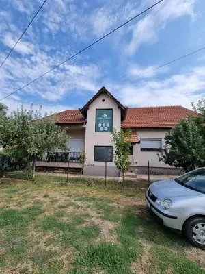 a house with a car parked in front of it at Apartman AM Mladenović in Vranje
