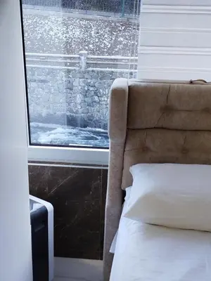 a bedroom with a bed and a large window at Lela lux in Jošanička Banja