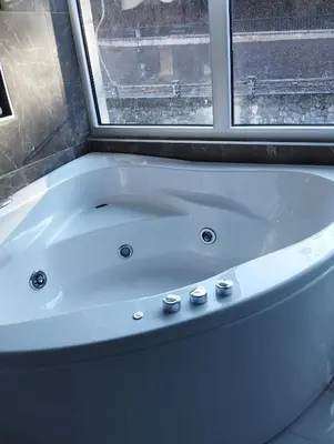 a white bath tub in a bathroom with a window at Lela lux in Jošanička Banja