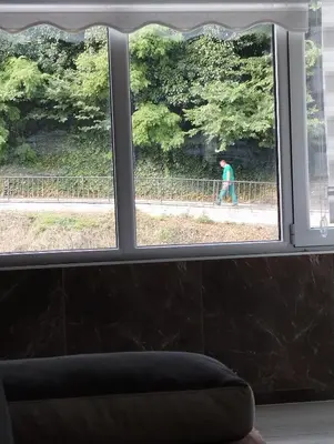 a person walking down a street seen through a window at Lela lux in Jošanička Banja