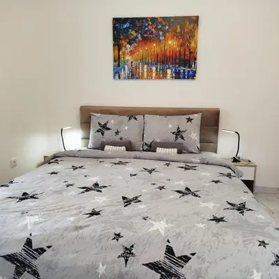 a bed with stars on it in a bedroom at Cera luxe apartment 2 in Soko Banja