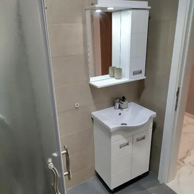 a bathroom with a white sink and a mirror at Cera luxe apartment 2 in Soko Banja