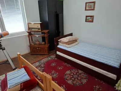 a bedroom with a bed with a red rug at Apartmani Feliks in Resavica