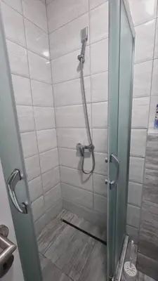 a shower with a glass door in a bathroom at Apartman Djordjevic in Soko Banja