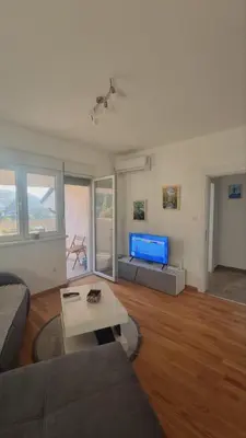 a living room with a couch and a table at Apartman Djordjevic in Soko Banja