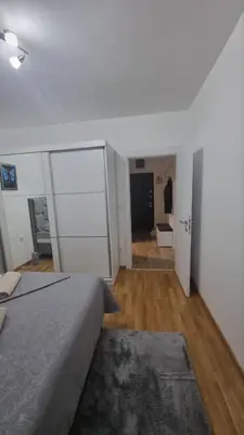 a bedroom with a bed and a room with a hallway at Apartman Djordjevic in Soko Banja
