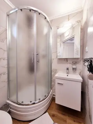 a shower in a bathroom with a sink and a toilet at Temački amanet in Pirot