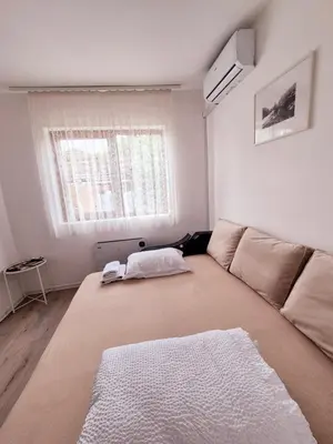a living room with a large couch and a window at Temački amanet in Pirot