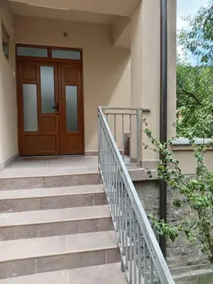 a set of stairs leading to a wooden door at Palamar in Kuršumlija