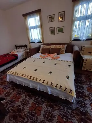 a bedroom with a bed and a couch at Seosko Domaćinstvo Jevtić in Ždraljica