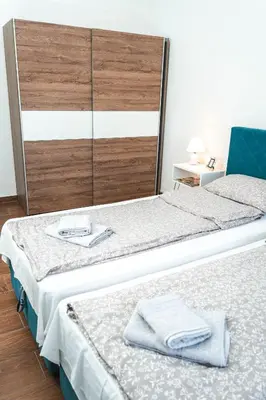 a bedroom with two beds with towels on them at Apartman Leskovčanka in Leskovac
