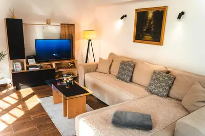 a living room with a couch and a tv at Apartman Leskovčanka in Leskovac