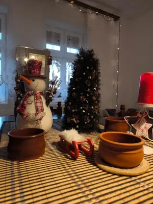 a table topped with a snowman and a christmas tree at Vila Kruna in Pirot