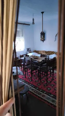 a living room with a table and a couch at Vila Kruna in Pirot