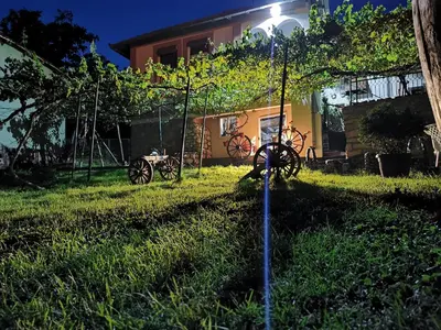 a group of wagon wheels in the yard of a house at Vila Kruna in Pirot